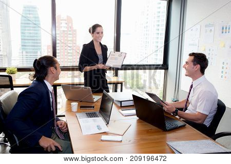 Businesswoman Presentation To A Group In Meeting.