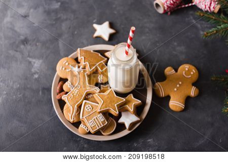 Milk and cookies. Gingerbread cookies on a gray background. Christmas cookies. Ginger men