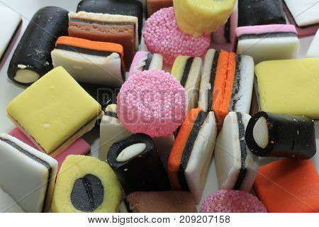 Pile of liquorice allsorts in different shapes colors and sizes