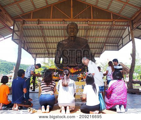 BANGKOK THAILAND - OCTOBER 08 2017: The tourists sit and pray in front of Luang Phu Sod statue at Buddha Uttayarn in Ban Na Dam Prachin Buri province Thailand.