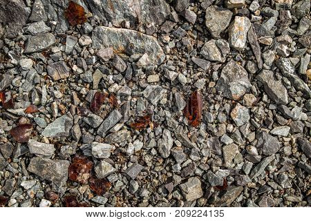 Shards of glass on shards of stone. Glass debris. Broken bottles. Background and texture