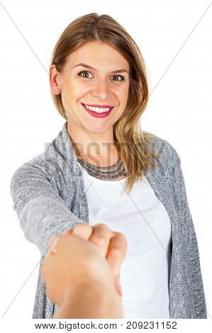 Attractive young woman holding her boyfriend's hand smiling at the camera on isolated background