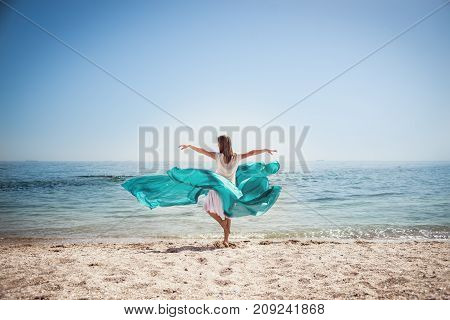 Beautiful blonde woman standing at the beach