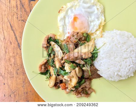 Thai Spicy Food Basil Pork Fried Rice Recipe (krapao Gai) With Fried Egg In Green Plate On Wooden Ba