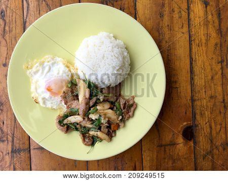 Thai Spicy Food Basil Pork Fried Rice Recipe (krapao Gai) With Fried Egg In Green Plate On Wooden Ba