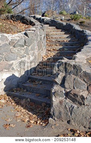 A bright day walked in the park with a Nikon camera. The bright sun on the steps painted a beautiful shadow. Stone steps are like a fairytale road this amazing play of light and shadow attracted my attention and in combination with a blue sky looks very b
