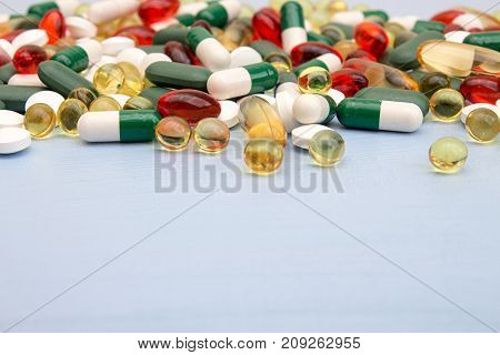 Pills Background. Heap Of Medicine Tablets And Pills In Blisters Different Colors On Blue Background