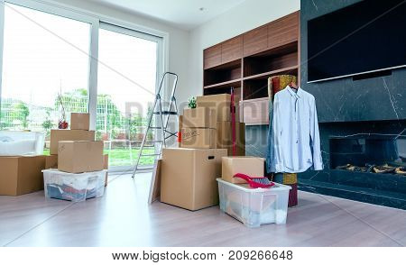 Large living room with stack of moving boxes