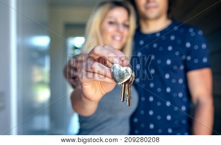 Happy couple showing the keys of their new house