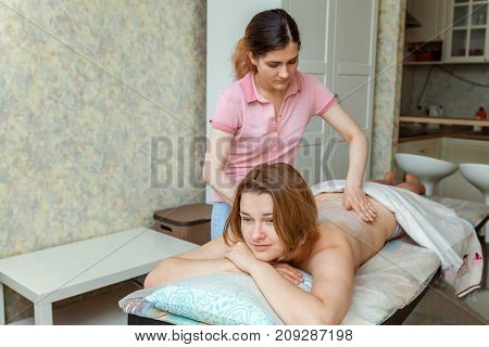 Beautiful young girl having massage in spa salon