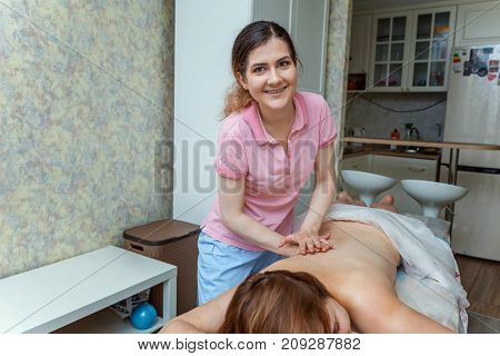 Beautiful young girl having massage in spa salon
