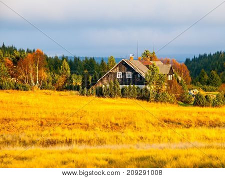 Wooden hut in Jizerka village. Sunny autumn day. Jizera Mountains, Czech Republic.