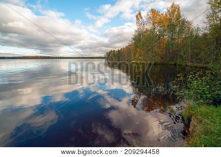 White clouds over the lake in the fall.
