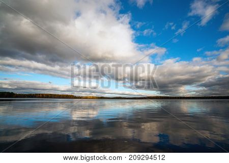 White clouds over the lake in the fall.