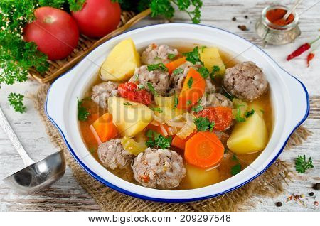 Meatballs in a thick vegetable soup Albondigas. Mexican and Spanish cuisine
