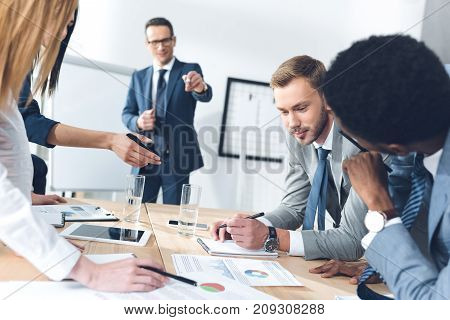 business parters having conversation at conference hall