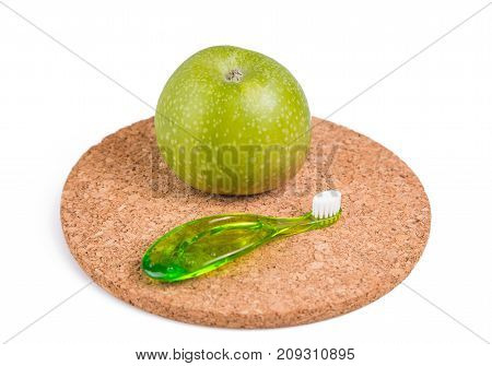 baby teeth care. green composition of toothbrush and teether on white background