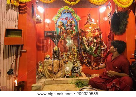 KOLKATA WEST BENGAL INDIA - 13 MAY 2017: Hindu priest worshipping Lord Hanuman known as Hanuman ji in India. Hindu religious persons are praying in front of the idol in the holy temple.