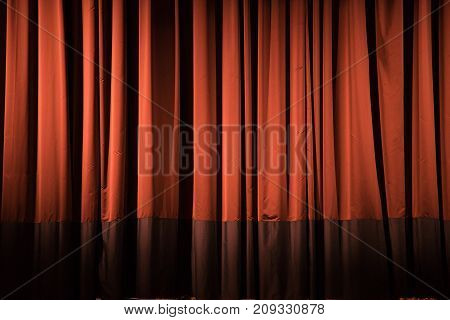 red theater curtain closed after reciting to december