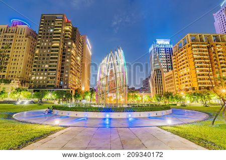 TAICHUNG TAIWAN - JULY 17: Contemporary architecture and park in the downtown area of Taichung at night on July 17 2017 in Taichung