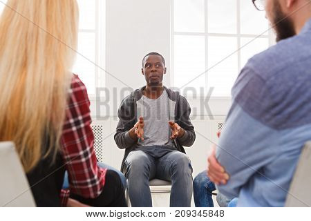 Meeting of support group. African-american man talking about his life, telling his problems and issues. Mental health, psychotherapy concept