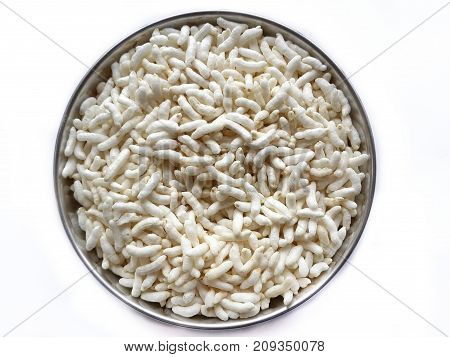 Puffed rice in plate isolated in white background.slective focus shot from above
