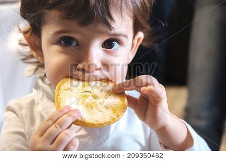 baby child eat carbohydrates - newborn eating face closeup portrait - unhealthy diet for kids