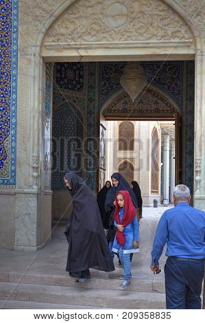 Fars Province Shiraz Iran - 19 april 2017: Shah Cheragh Shrine Iranian people pass through the large gate of mosque.