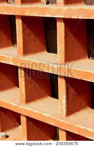 Old orange tractor grill macro grungy background texture