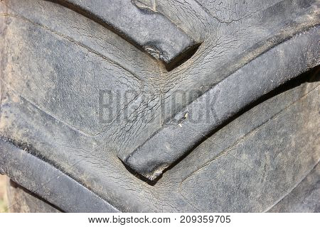 Old cracked tractor tire macro background texture