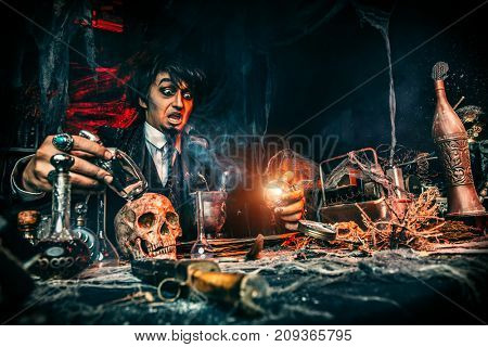 Portrait of a medieval scientist working in his laboratory. Alchemist. Halloween.