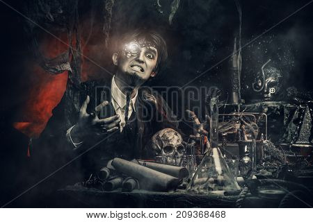 Portrait of a medieval scientist working in his laboratory. Alchemist. Halloween.