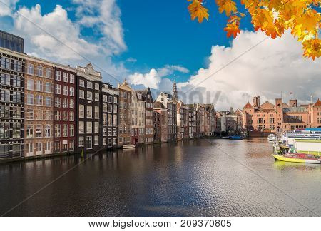 Typical dutch old houses over canal, Amstardam, Netherlands at autumn day