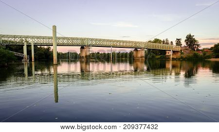 Green metallic bridge over the Saone river