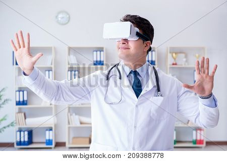 Young doctor with vr virtual reality headset working in the offi