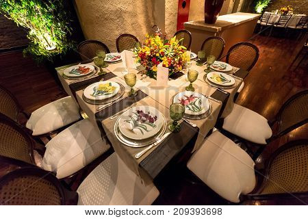 SAO PAULO BRAZIL - OCTOBER 07 2017: Wide angle picture of decorated table for dinner with beautiful plates with flowers for a wedding party in the city of Sao Paulo Brazil.
