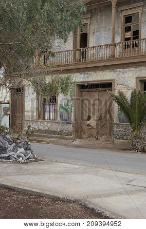 Pisagua, Tarapaca Region, Chile - August 30, 2017: Historic wooden buildings from the era of nitrate mining in the Atacama Desert, in the coastal town of Pisagua in northern Chile.