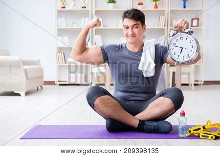 Young man exercising at home in sports and healthy lifestyle con