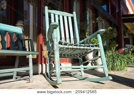 January 9 2016 Goliad Texas USA: rocking chair in the shade of awning in front of a store in historic downtown