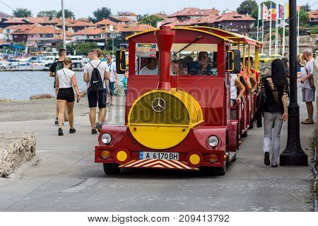 NESEBAR BULGARIA - AUGUST 21 2017: Stylized for the locomotive with the carriages a walking road train. Nesebar is an ancient city and one of the major seaside resorts on the Bulgarian Black Sea Coast.