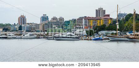 NESEBAR BULGARIA - AUGUST 21 2017: Marina for yachts and boats in the UNESCO World Heritage town of Nesebar. In the background modern houses of the new town.