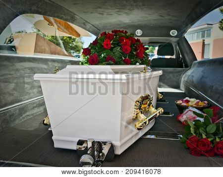 closeup shot of a colorful casket in a hearse or chapel before funeral or burial at cemetery