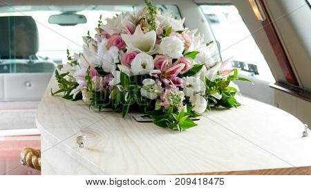 closeup shot of a colorful casket in a hearse or chapel before funeral or burial at cemetery