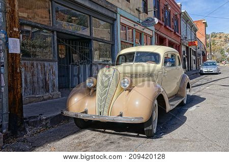 December 9, 2015 Bisbee Arizona USA: vintage collector's car parked in the front of victorian-style bulidings Bisbee earned the title of Best Historic Small Town in several magazines