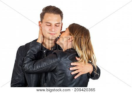 Sensual young woman kissing his boyfriend's neck on isolated background