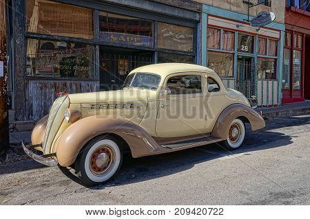 December 9, 2015 Bisbee Arizona USA: vintage collector's car parked in the front of victorian-style bulidings Bisbee earned the title of Best Historic Small Town in several magazines