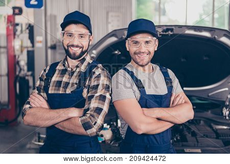 Attractive Cheerful Experts At Work Shop, Standing In Special Blue Safety Outfit Uniform, Checkered