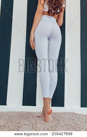 Legs of a sexy girl in white leggings. Mock-up.