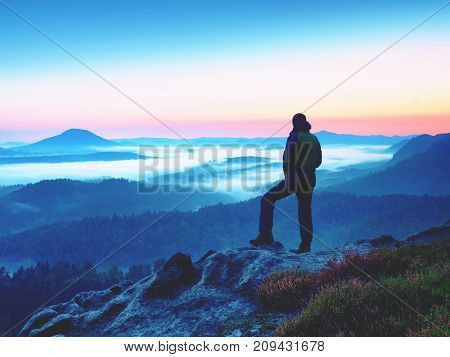 Hiker  Man On Rock Watch Over Creamy Mista And Foggy Morning Landscape.