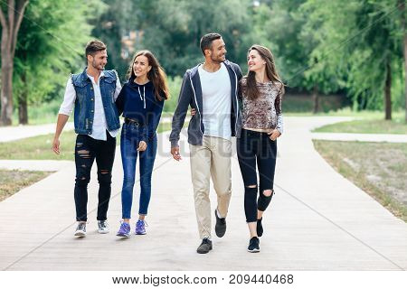 Two Beautiful Young Lovers Couple Walking In Summer Park